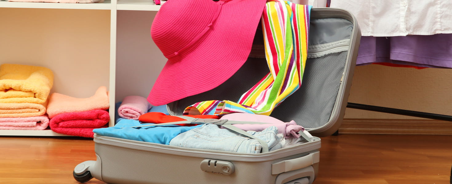 Carry-On Suitcase, open and being packed with clothes
